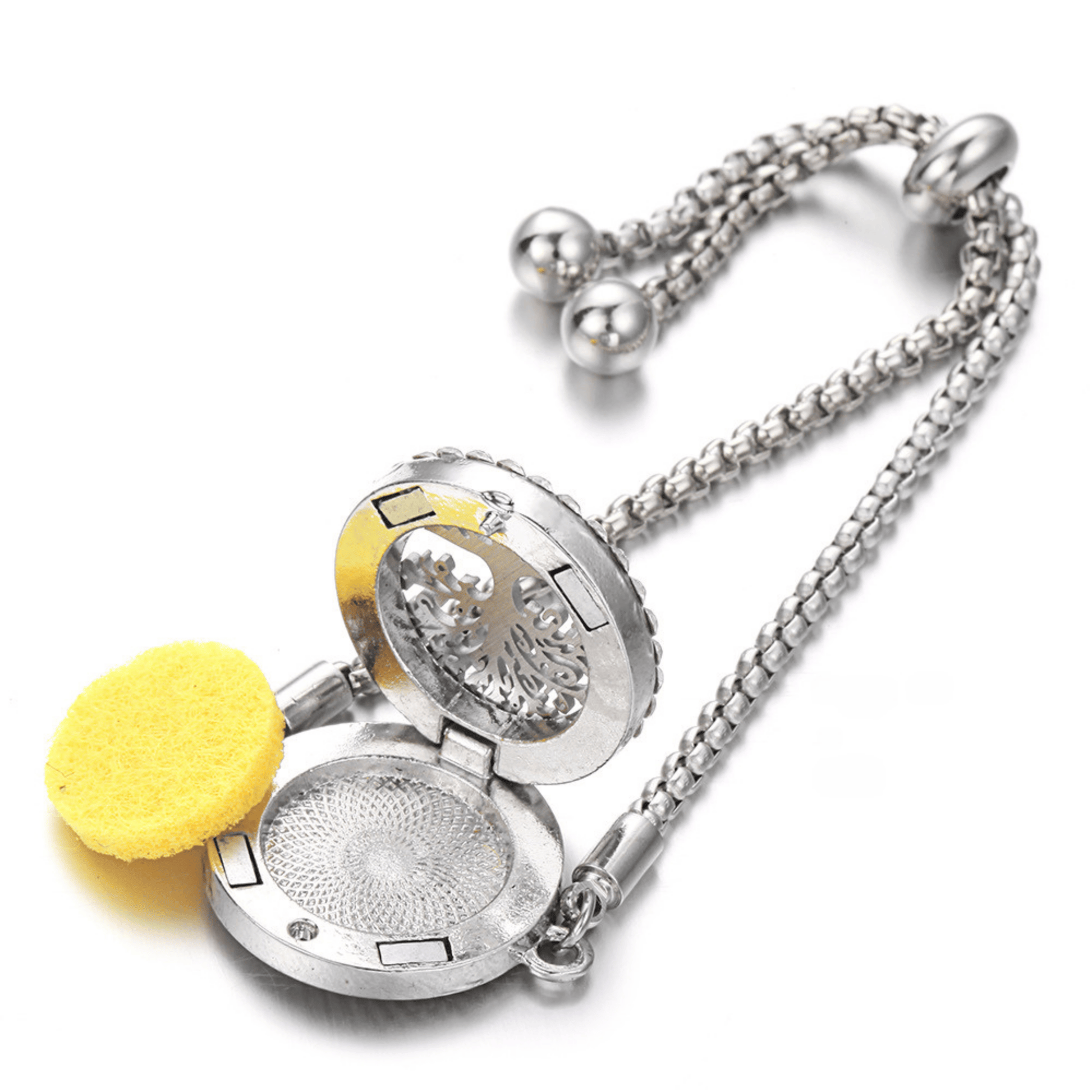 Silver aromatherapy locket bracelet featuring an intricate floral design and a yellow felt pad for essential oils, offering a stylish and functional accessory for fragrance diffusion.