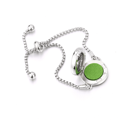 Silver Fragrance bracelet with an open locket diffuser containing a green felt pad insert for aromatherapy or essential oil use.